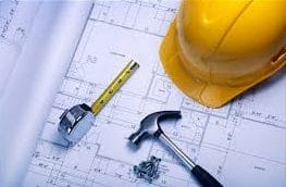 Construction Plans with Hard Hat, Hammer, and Tape Measure