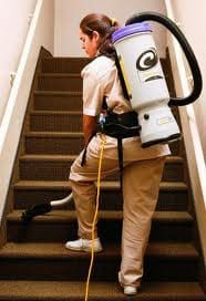 Person Vacuuming Stairs Wearing Backpack Vacuum
